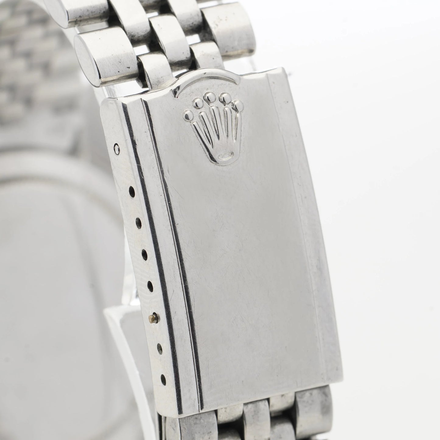 Close-up of a Rolex watch clasp, on a white background