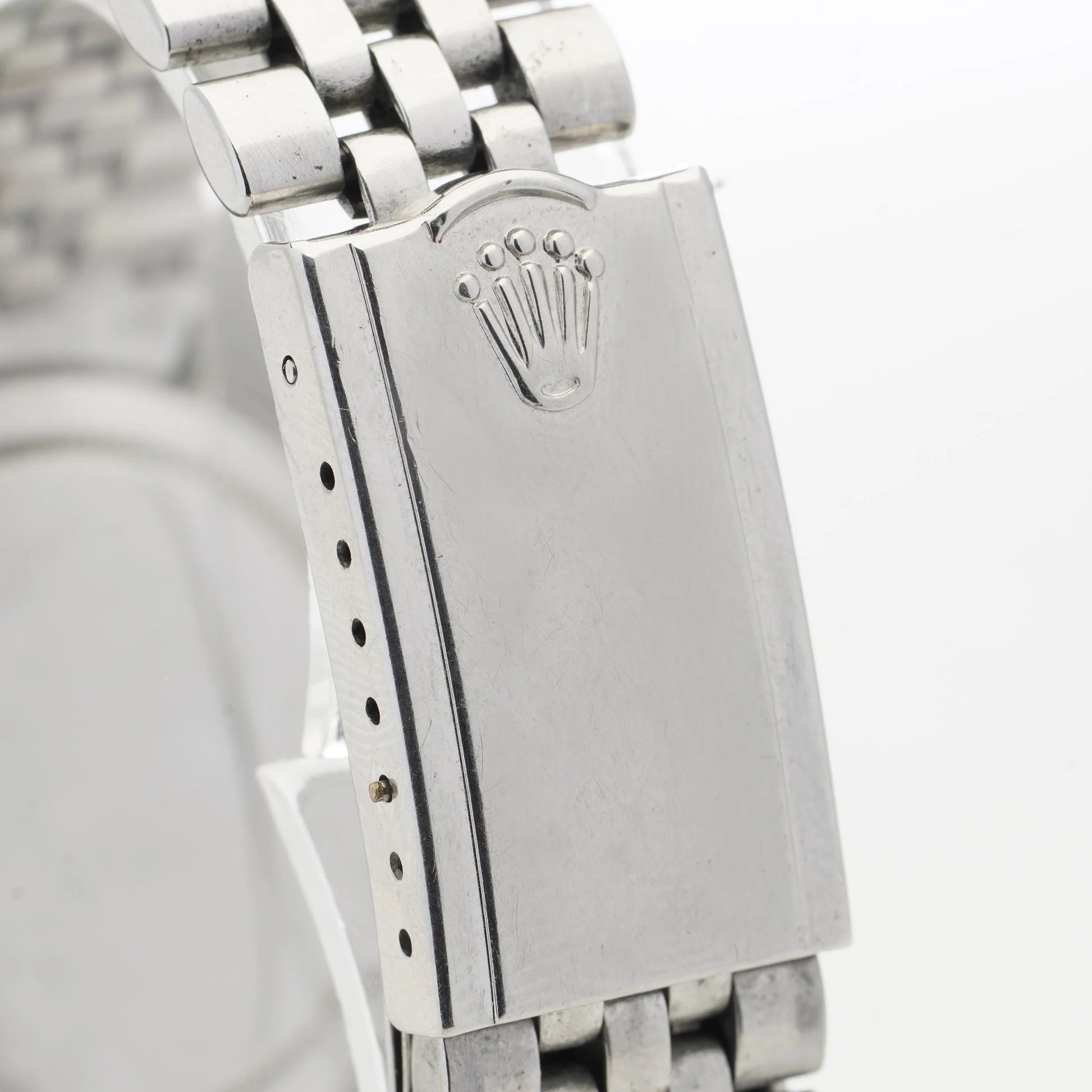 Close-up of a Rolex watch clasp, on a white background