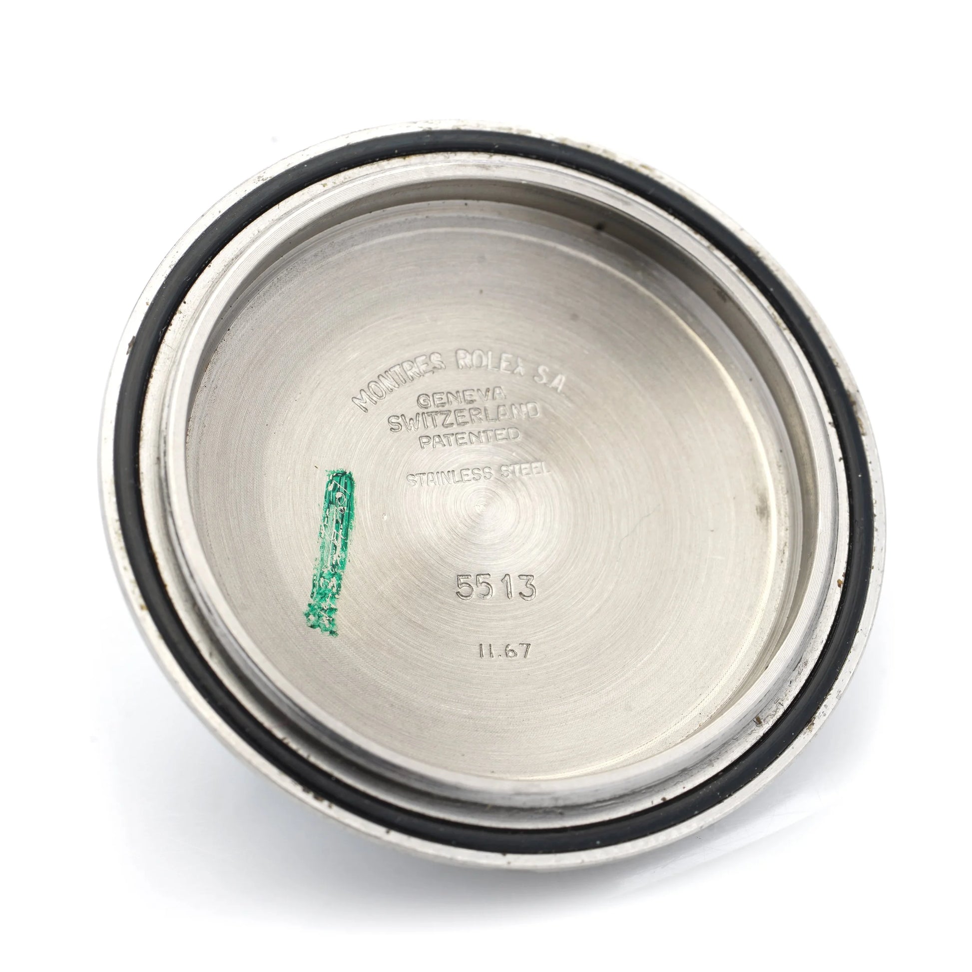 A steel Rolex watch case back, on a white background
