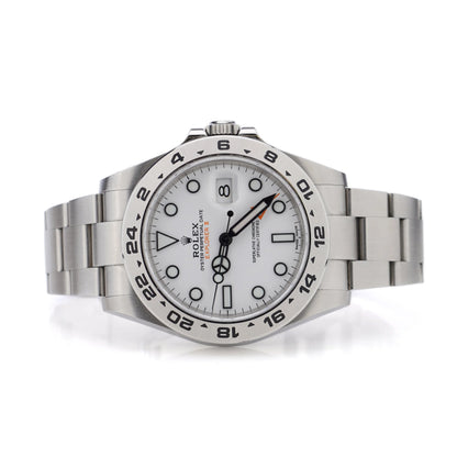 A Rolex Explorer II steel wristwatch with white dial, on a white background