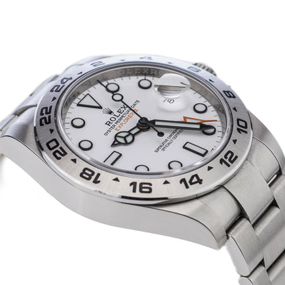 A Rolex Explorer II steel wristwatch with white dial, on a white background