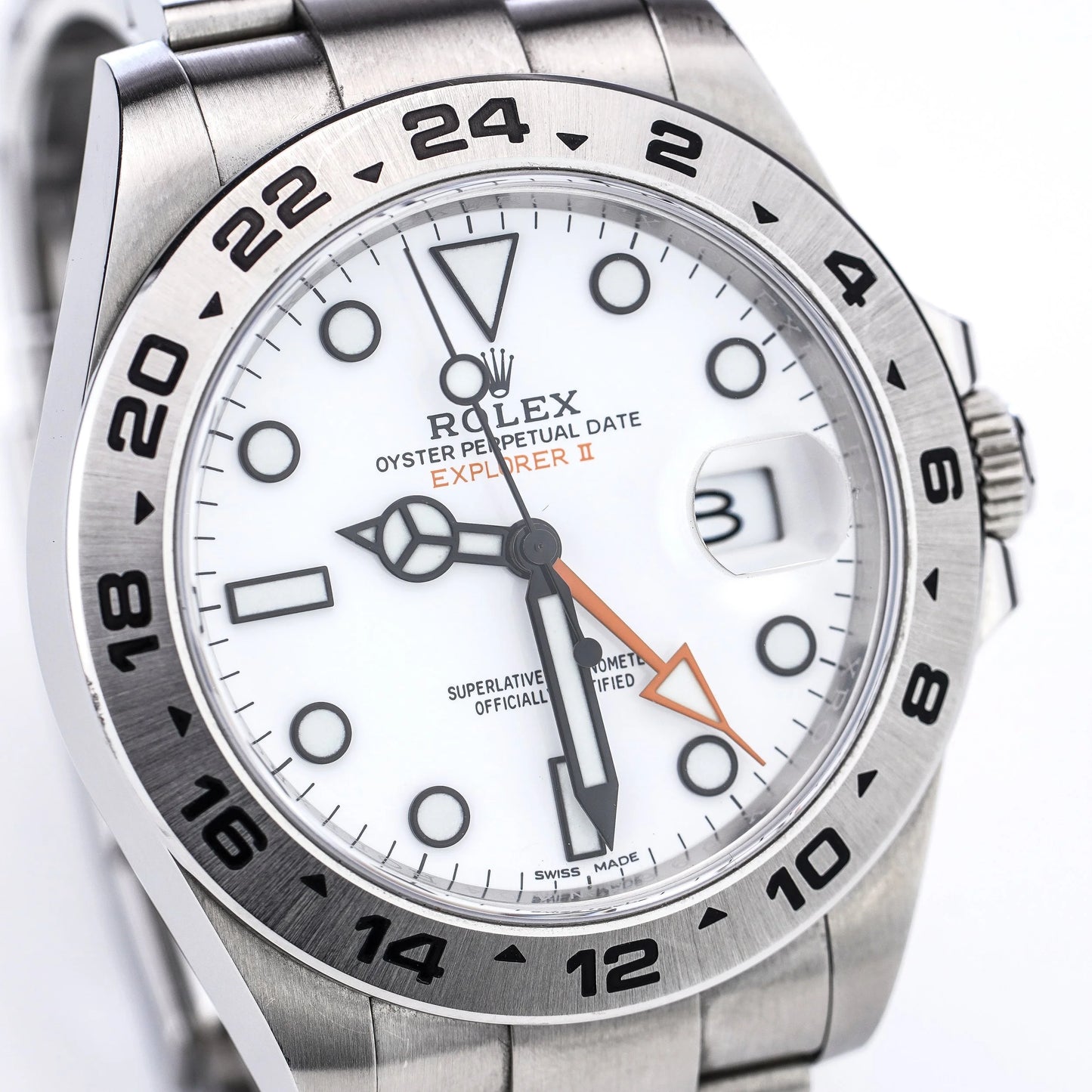A Rolex Explorer II steel wristwatch with white dial, on a white background