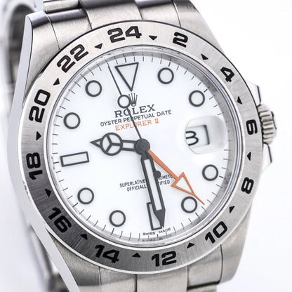 A Rolex Explorer II steel wristwatch with white dial, on a white background
