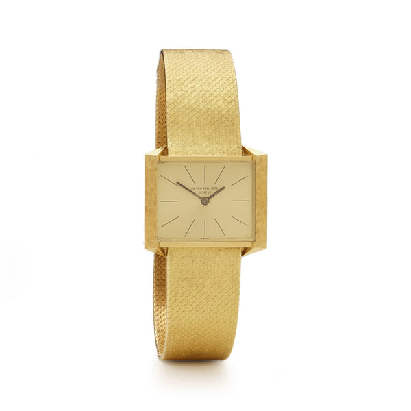 A yellow gold Patek Phillipe wristwatch with integrated bracelet, on a white background