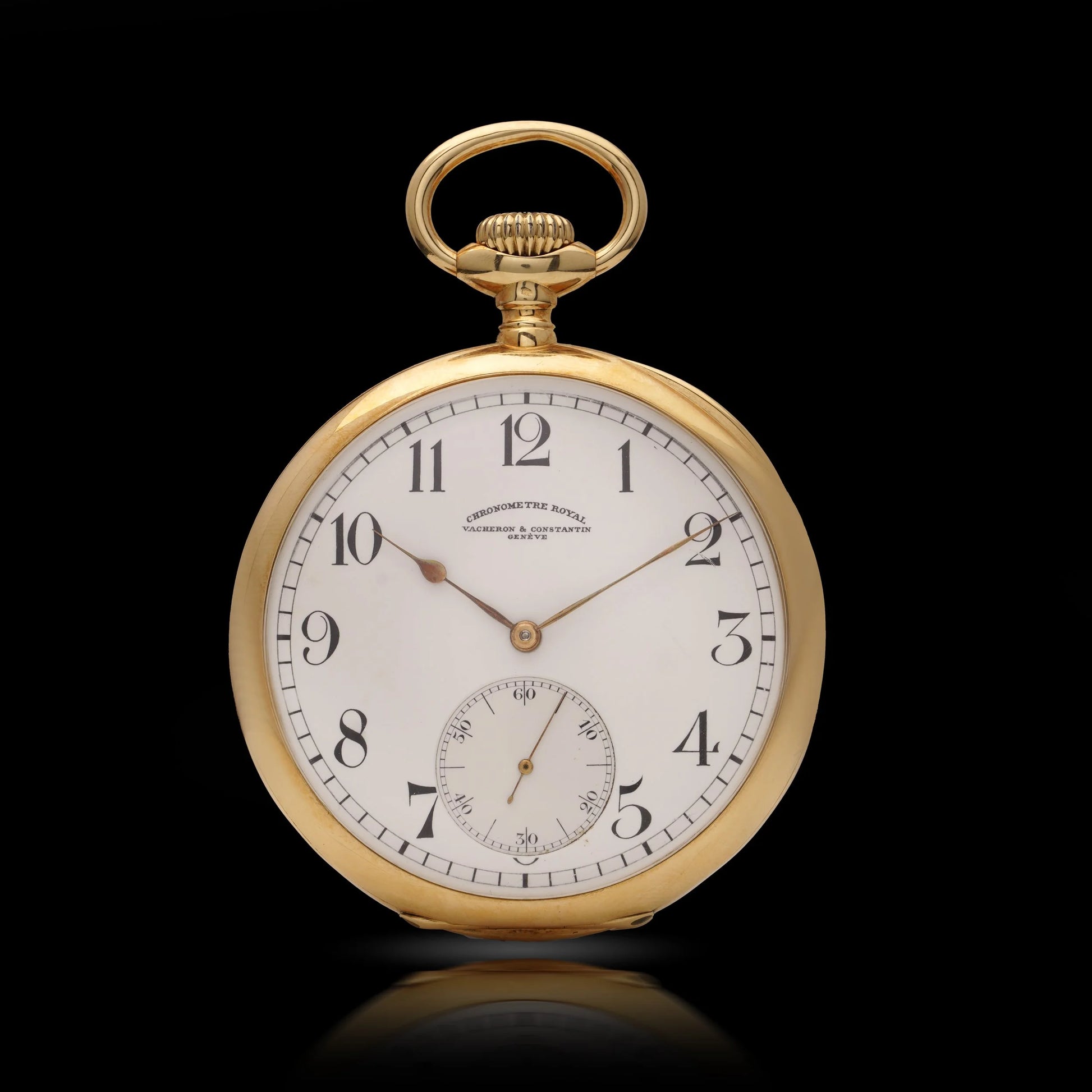 A yellow gold Vacheron & Constantin pocket watch with a white dial and black Arabic numbers, on a black background