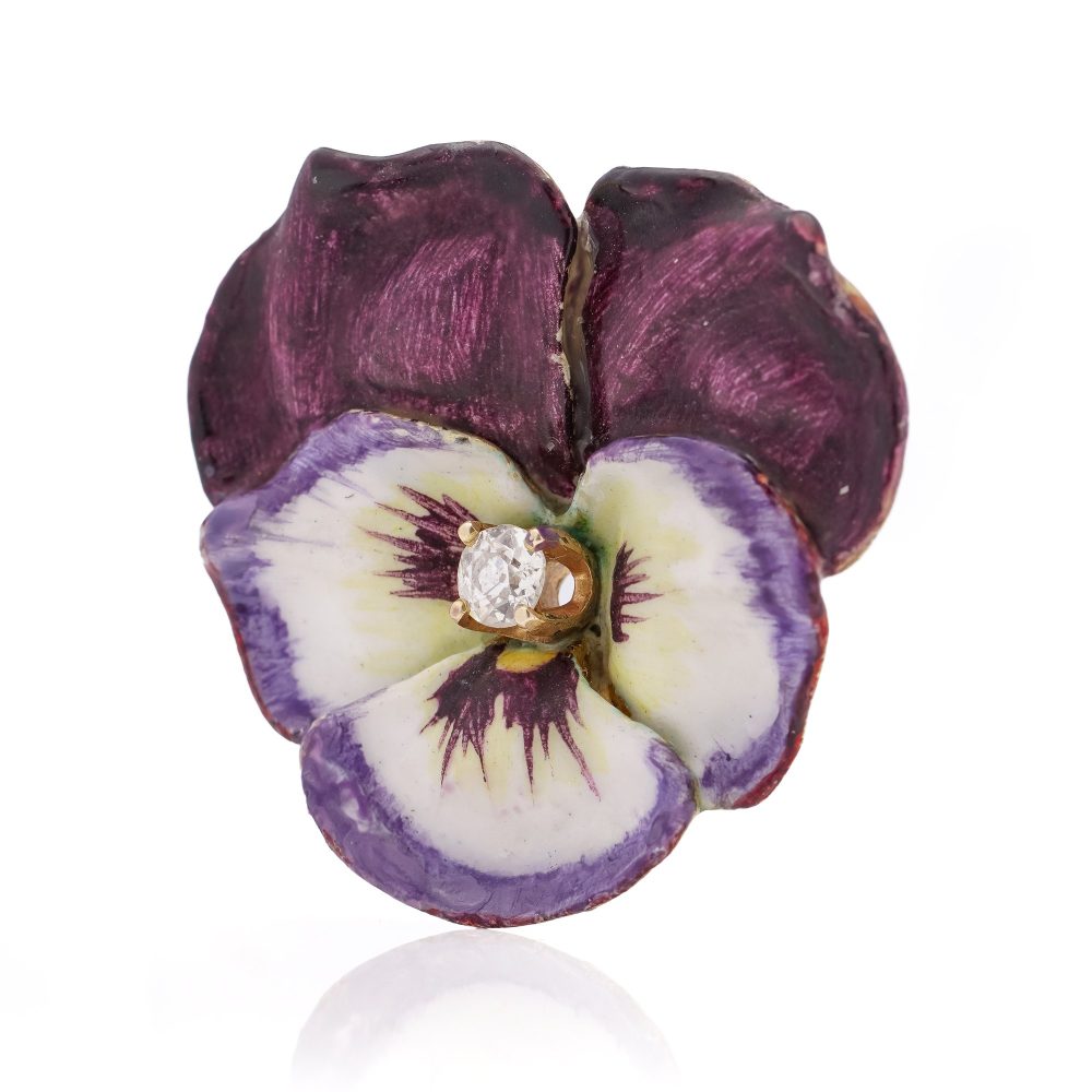 Gold flower brooch with enamel and an old-European cut diamond.