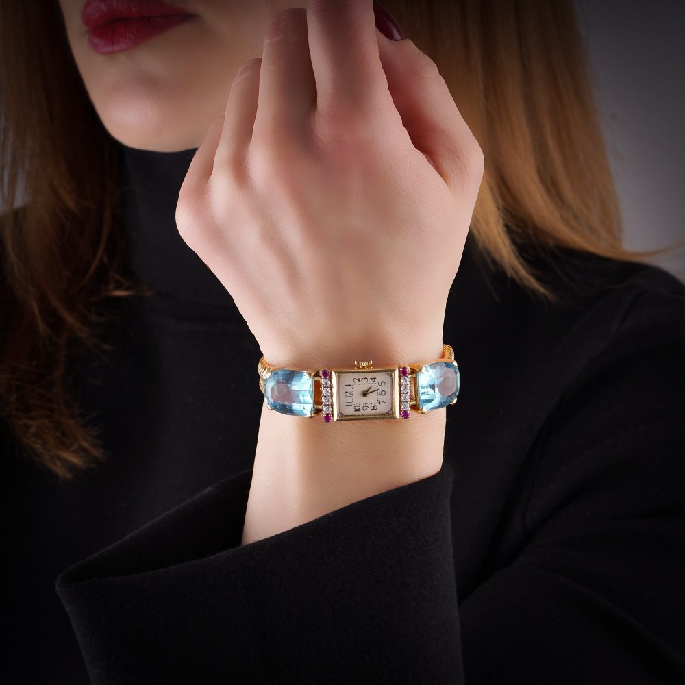 Ladies gold cocktail watch with Gemstones.