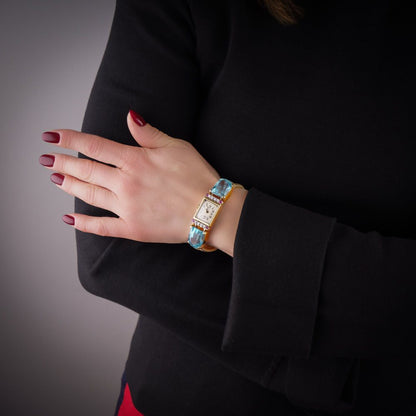 Ladies gold cocktail watch with Gemstones.