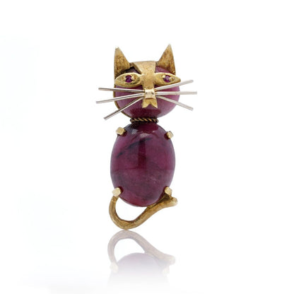 Vintage gold cat-shaped brooch with ruby eyes.