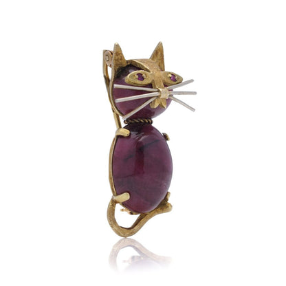 Vintage gold cat-shaped brooch with ruby eyes.