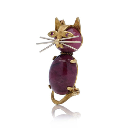 Vintage gold cat-shaped brooch with ruby eyes.