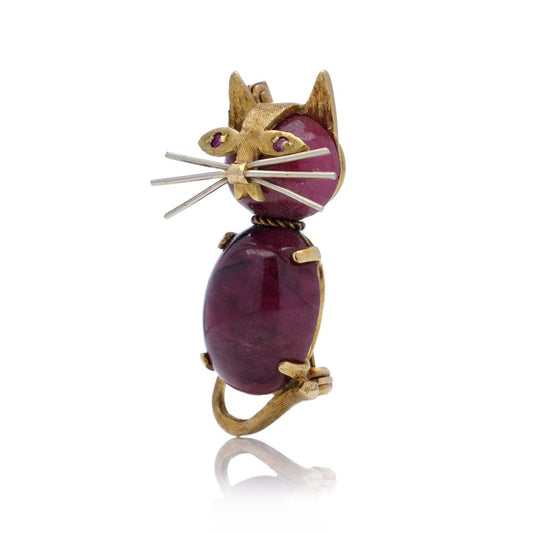 Vintage gold cat-shaped brooch with ruby eyes.