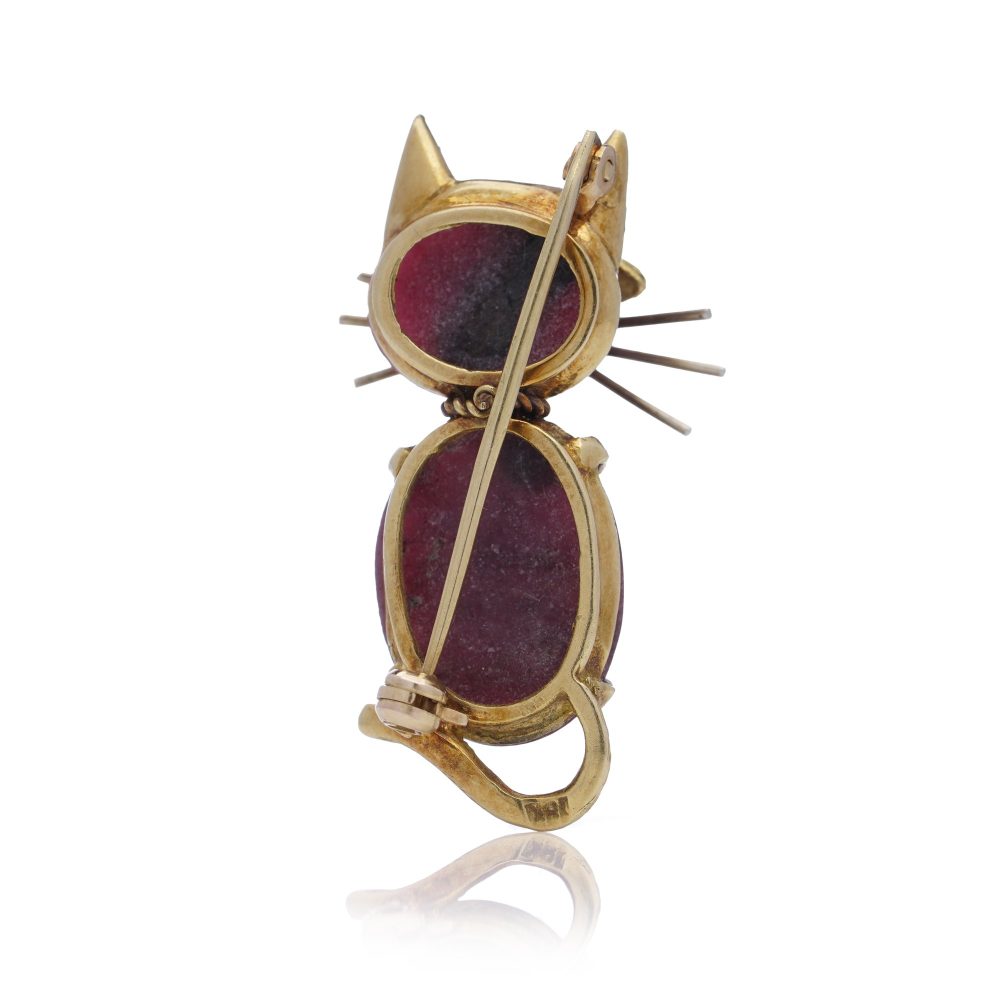 Vintage gold cat-shaped brooch with ruby eyes.