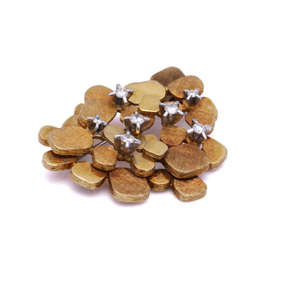 Vintage gold textured petal design diamond brooch.