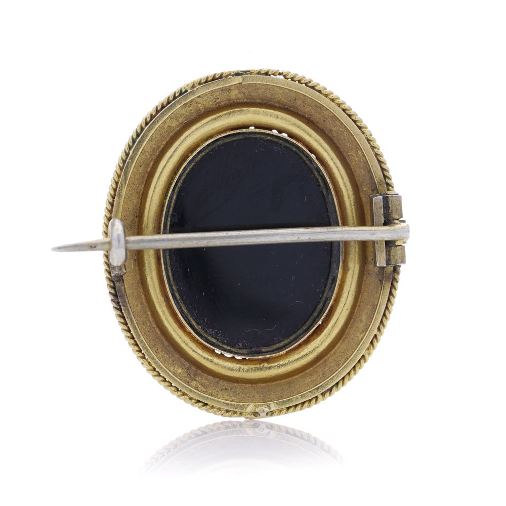 Antique gold onyx cameo brooch.