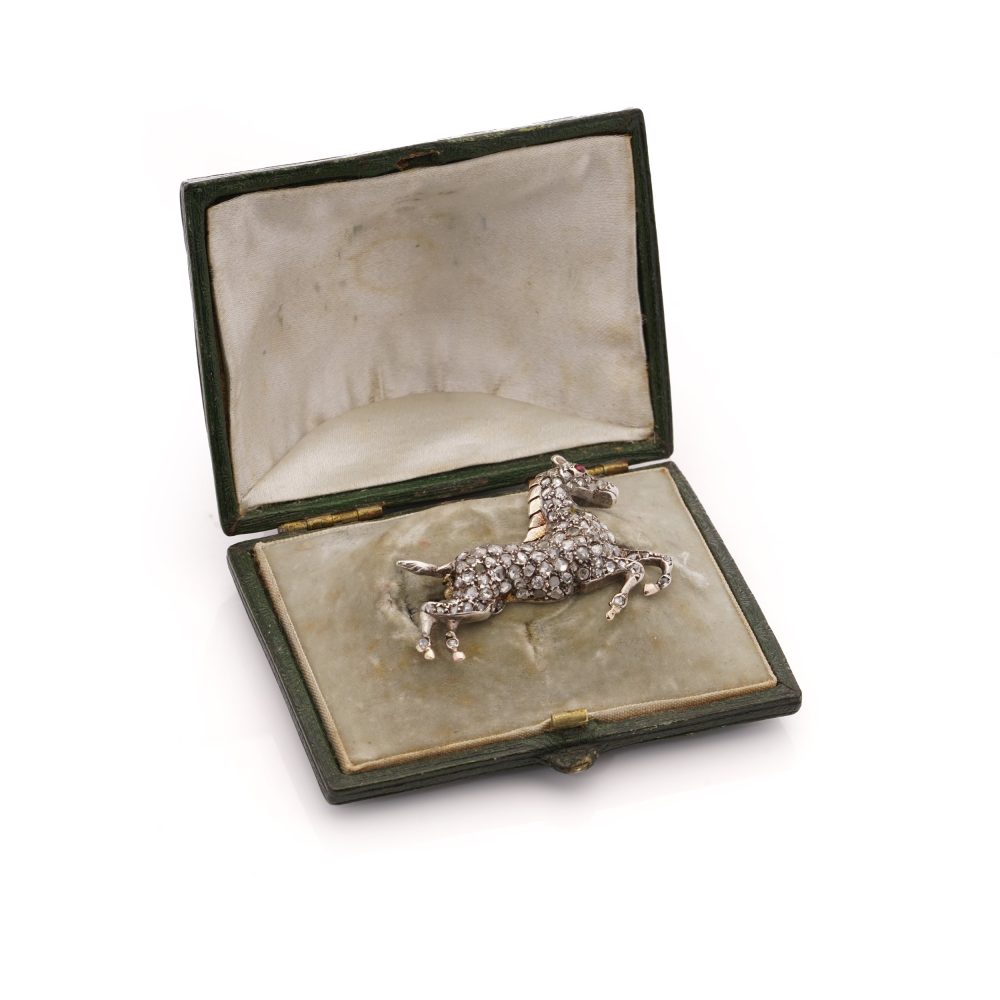 Victorian silver and gold plated horse brooch with diamonds and ruby.