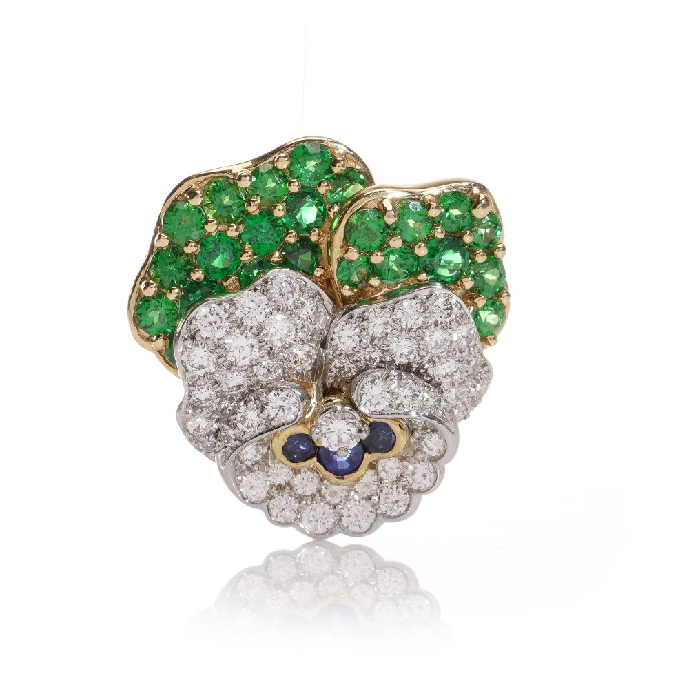 Tiffany & Co brooch in gold and platinum with tsavorite garnets, diamonds, and sapphires.