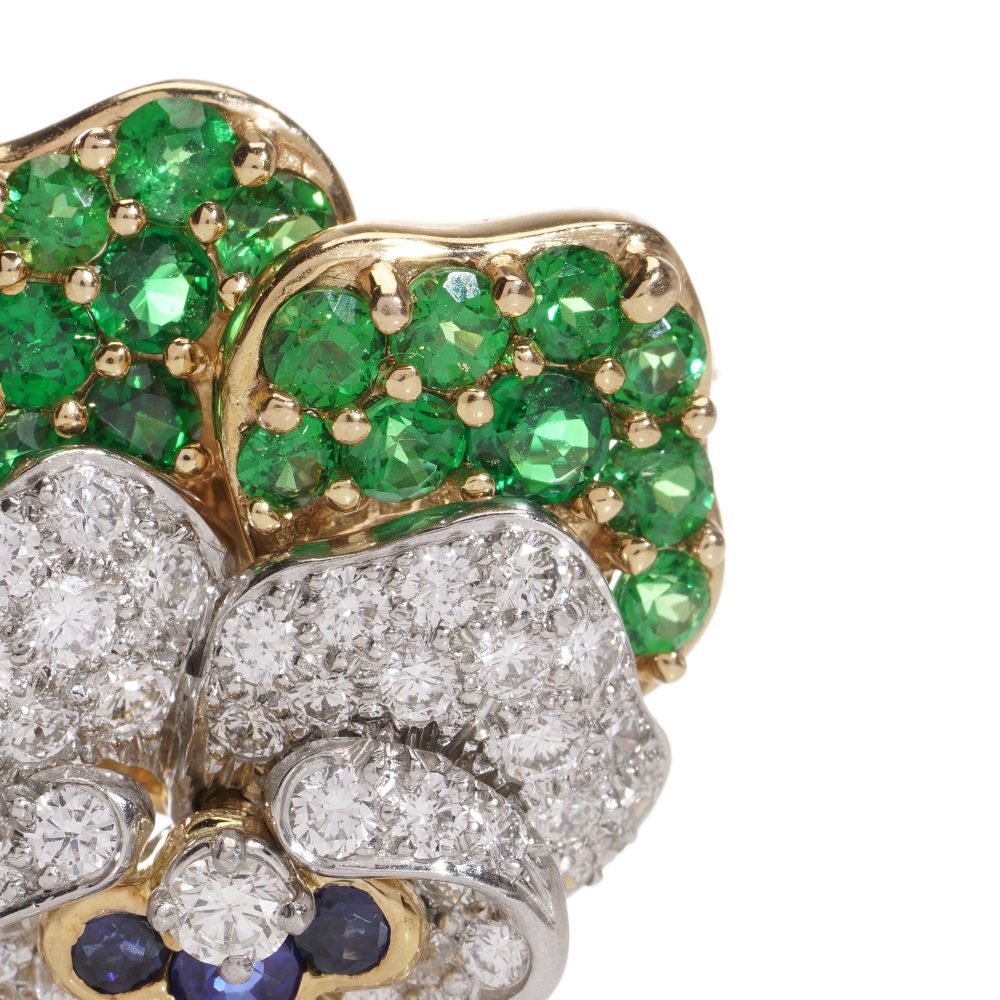 Tiffany & Co brooch in gold and platinum with tsavorite garnets, diamonds, and sapphires.