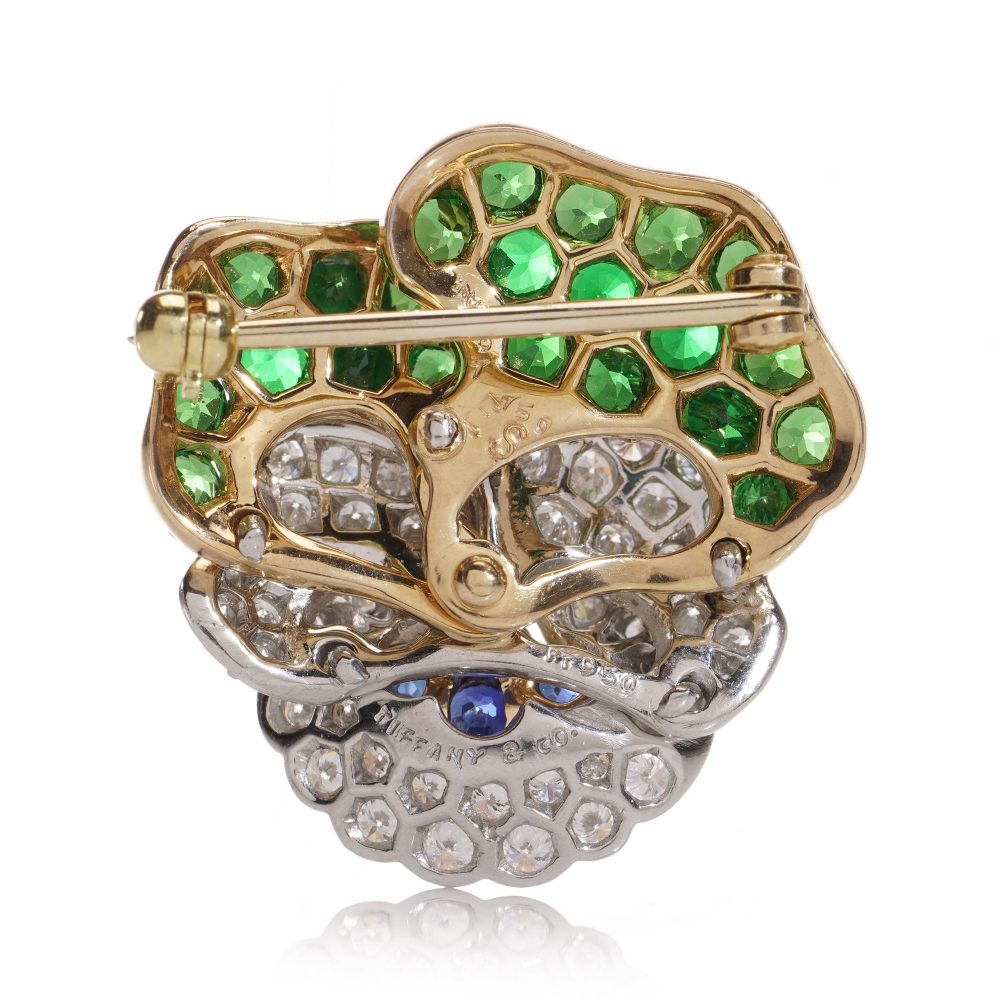 Tiffany & Co brooch in gold and platinum with tsavorite garnets, diamonds, and sapphires.