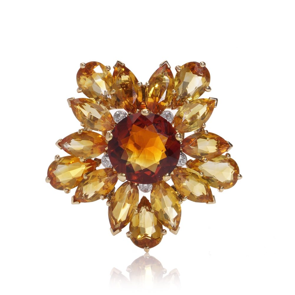 Gold sunflower brooch with garnet, topaz and diamonds.