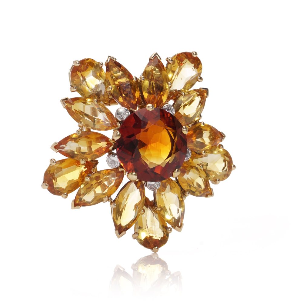 Gold sunflower brooch with garnet, topaz and diamonds.