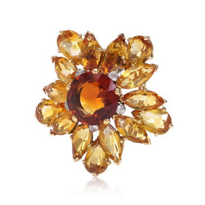 Gold sunflower brooch with garnet, topaz and diamonds.