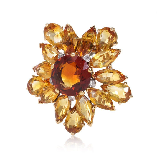 Gold sunflower brooch with garnet, topaz and diamonds.