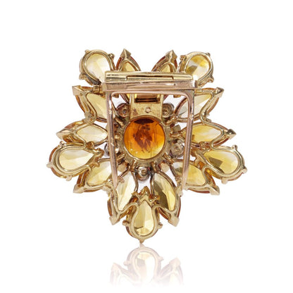 Gold sunflower brooch with garnet, topaz and diamonds.