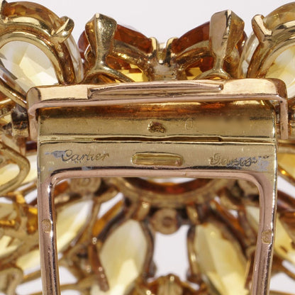 Gold sunflower brooch with garnet, topaz and diamonds.