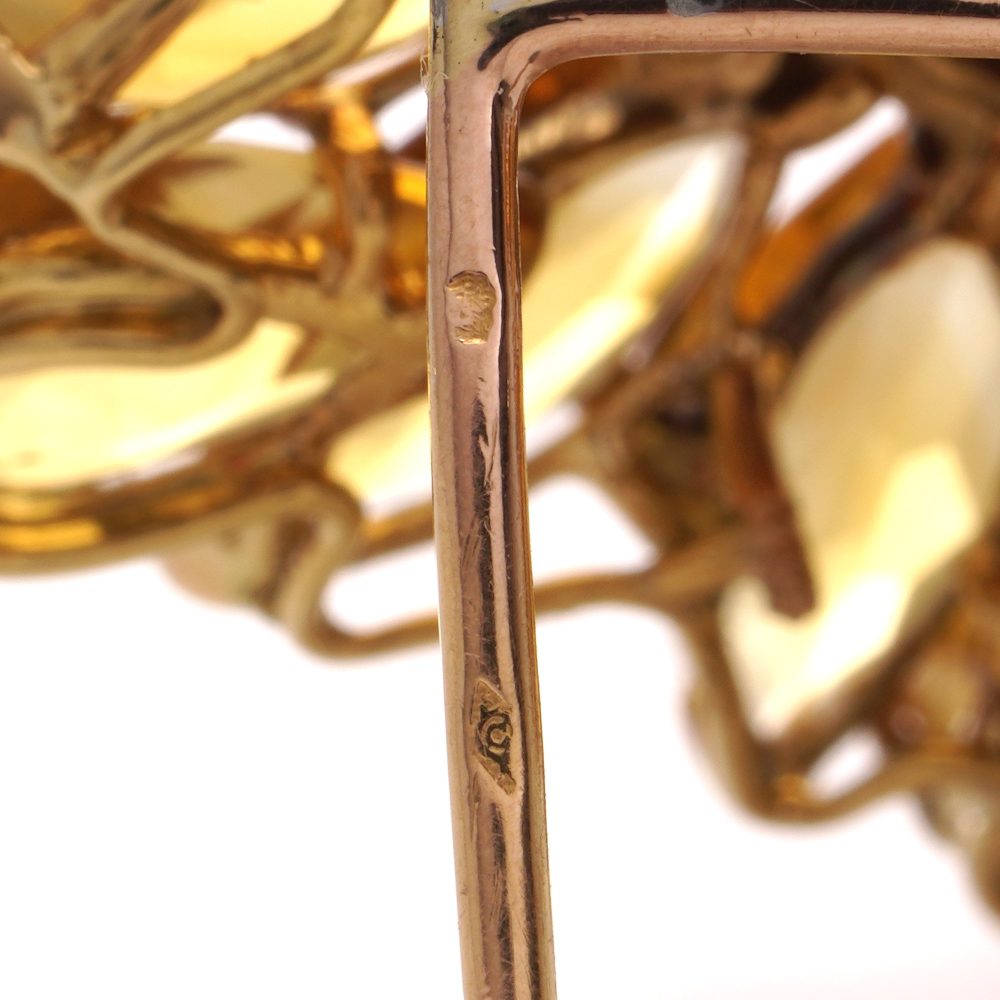 Gold sunflower brooch with garnet, topaz and diamonds.