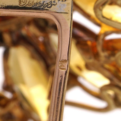 Gold sunflower brooch with garnet, topaz and diamonds.