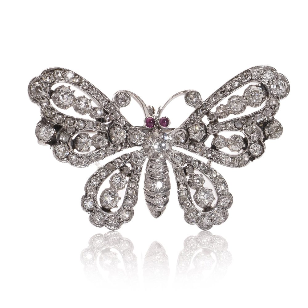 Antique white gold and silver butterfly brooch with diamonds and rubies.
