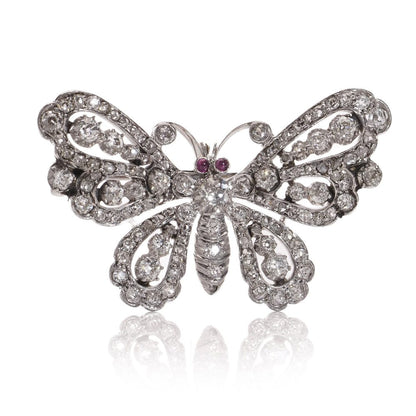 Antique white gold and silver butterfly brooch with diamonds and rubies.