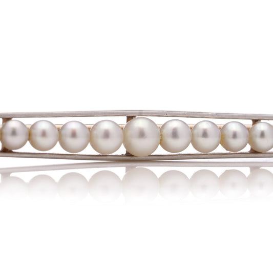 Gold and platinum elongated brooch adorned with pearls
