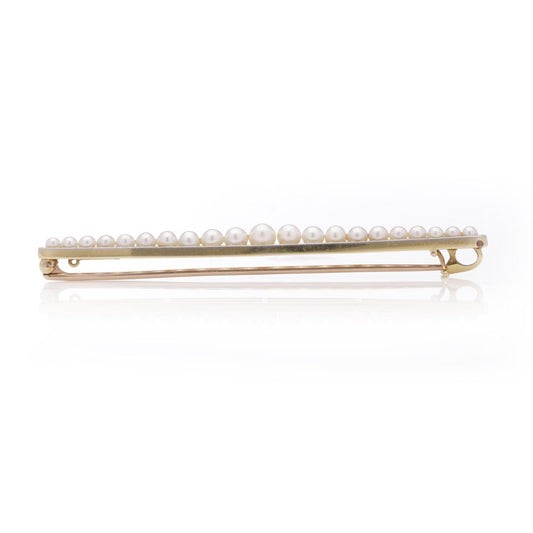 Gold and platinum elongated brooch adorned with pearls
