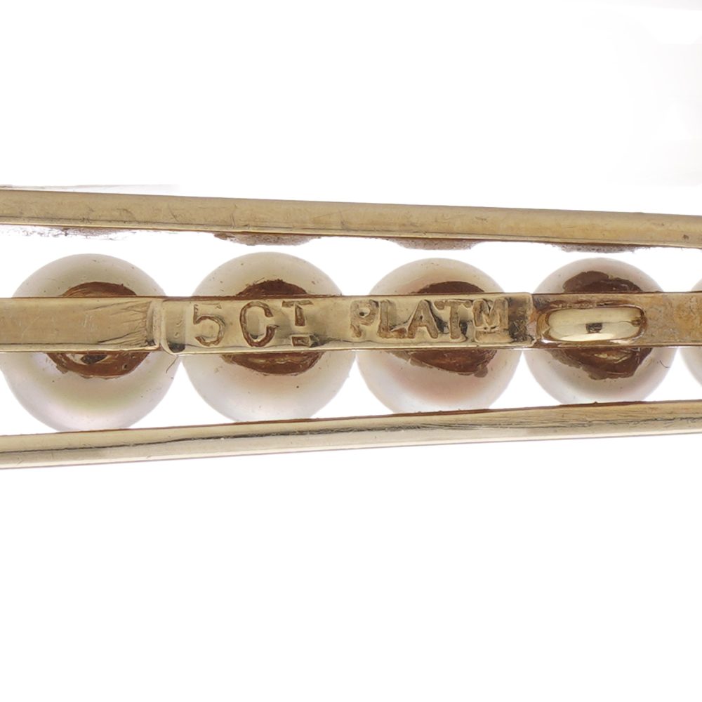 Gold and platinum elongated brooch adorned with pearls