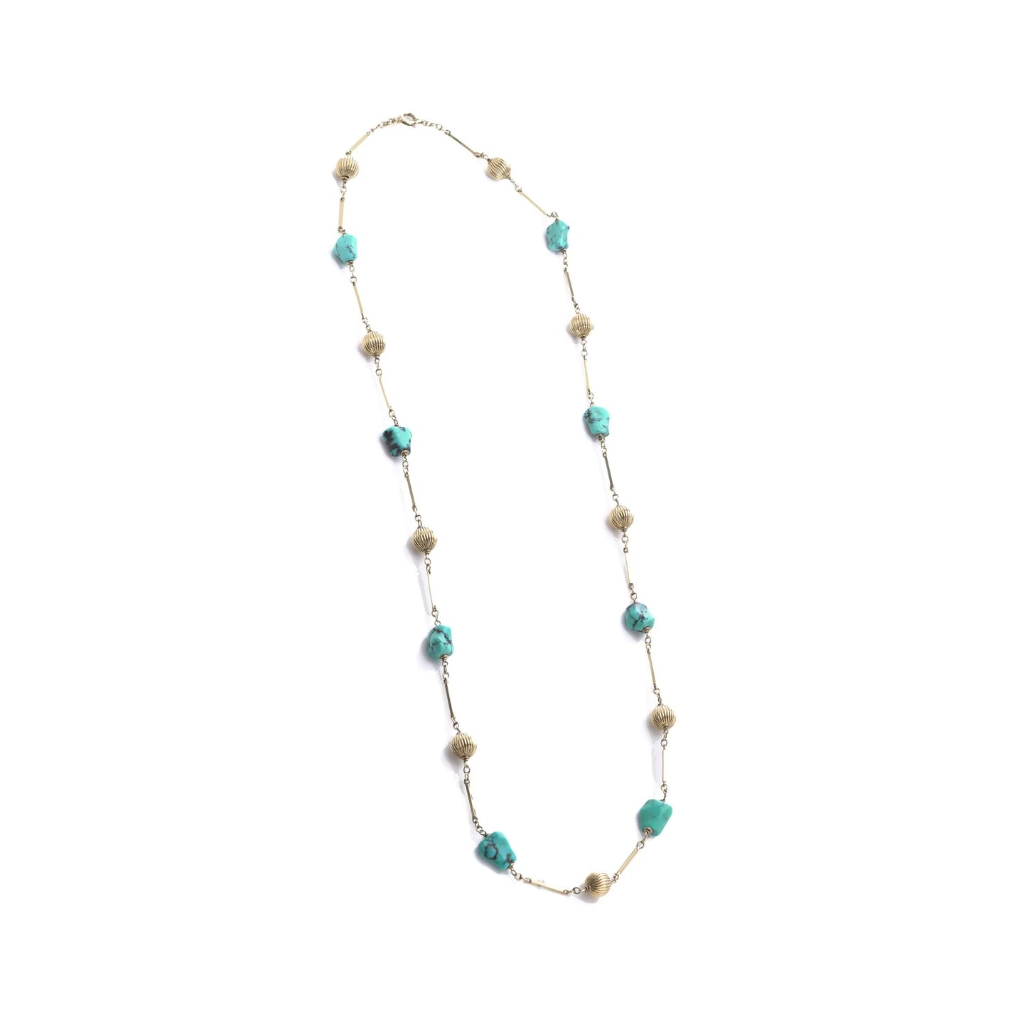 A yellow gold long chain necklace with turquoise nuggets, on a white background