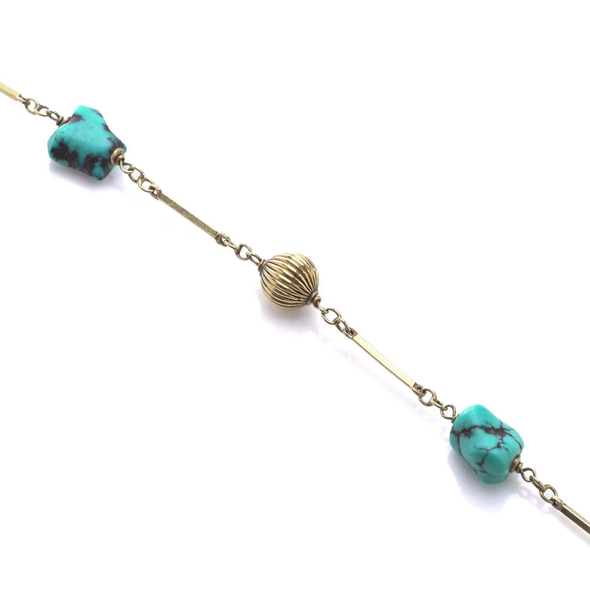 A yellow gold long chain necklace with turquoise nuggets, on a white background