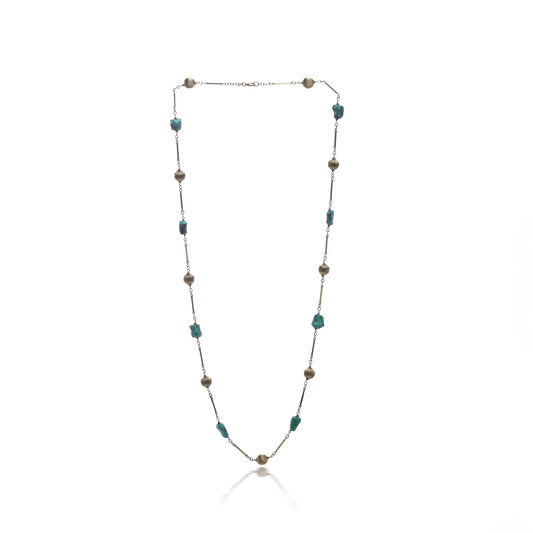 A yellow gold long chain necklace with turquoise nuggets, on a white background