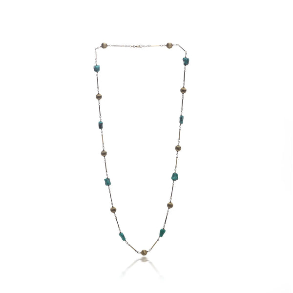 A yellow gold long chain necklace with turquoise nuggets, on a white background