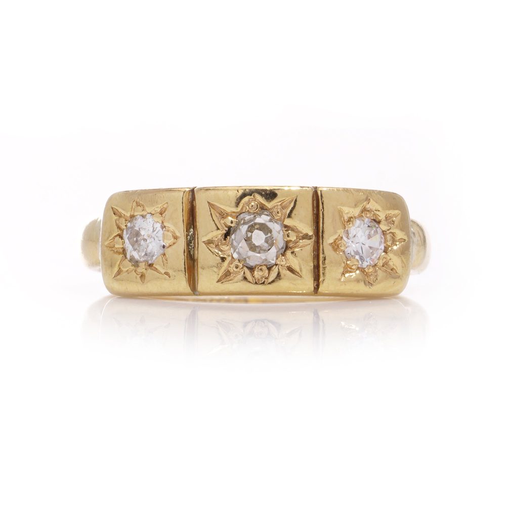 Vintage three-stone diamond ring in gold.