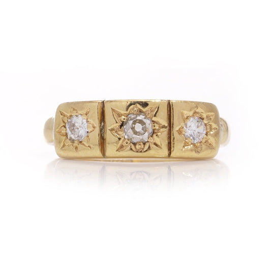 Vintage three-stone diamond ring in gold.