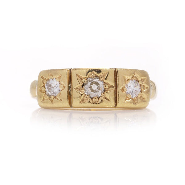 Vintage three-stone diamond ring in gold.