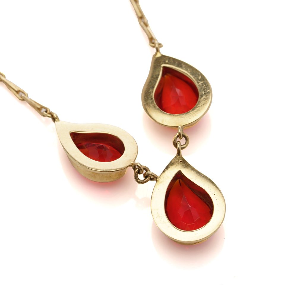 Gold pendant necklace with three fire opals.