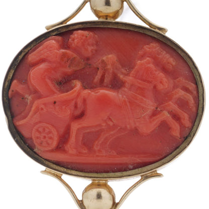 Victorian pocket watch key/pendant in gold and carved coral showing neoclassical scenes.