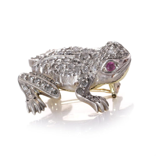 An Edwardian frog brooch in gold and silver set with diamonds and rubies.