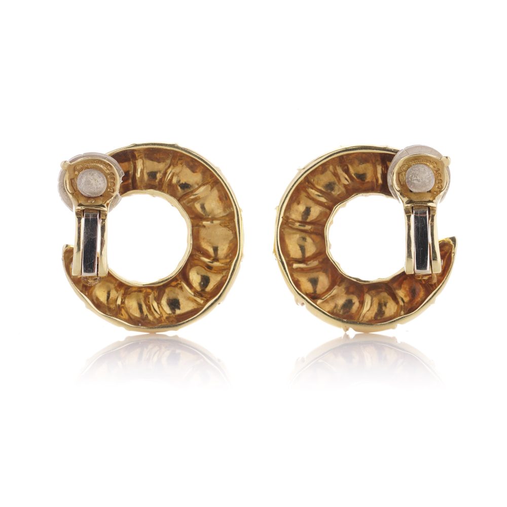 Scalloped clip earrings in gold .