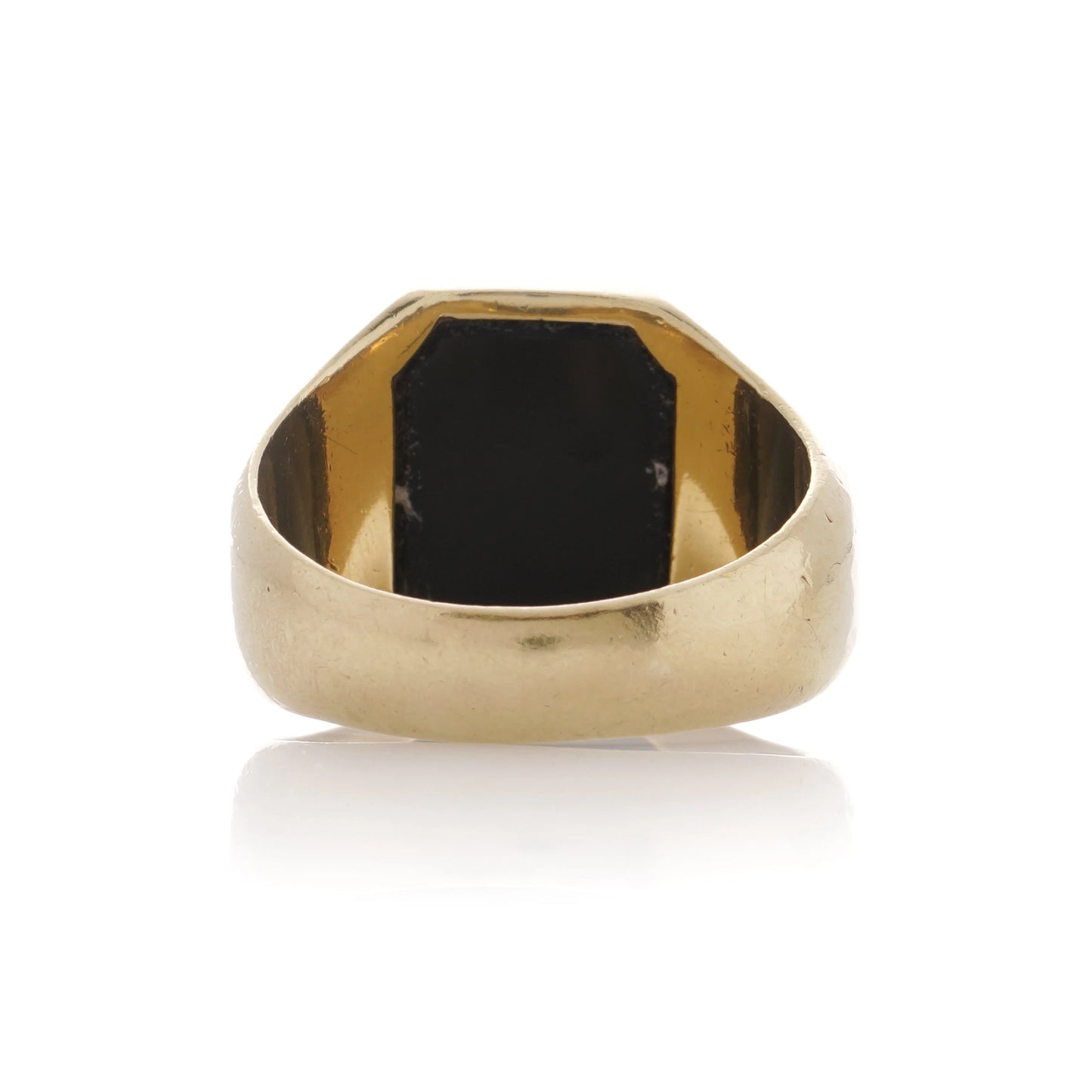 A yellow gold ring from behind, on a white background