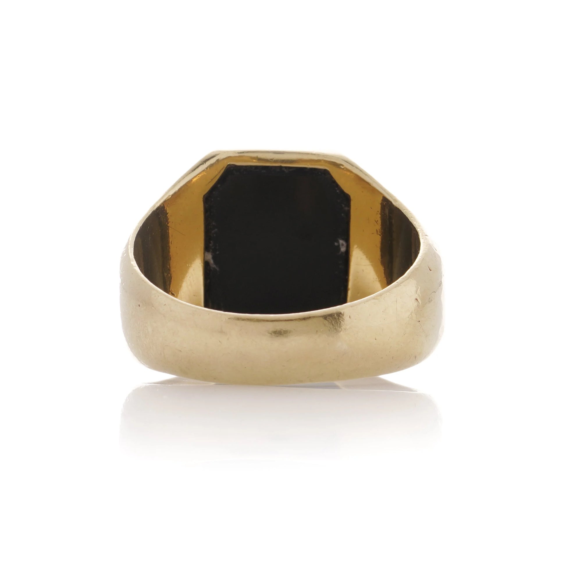 A yellow gold ring from behind, on a white background