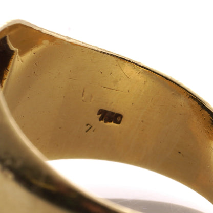 A 750 stamp inside ayellow gold ring shank, on a white background
